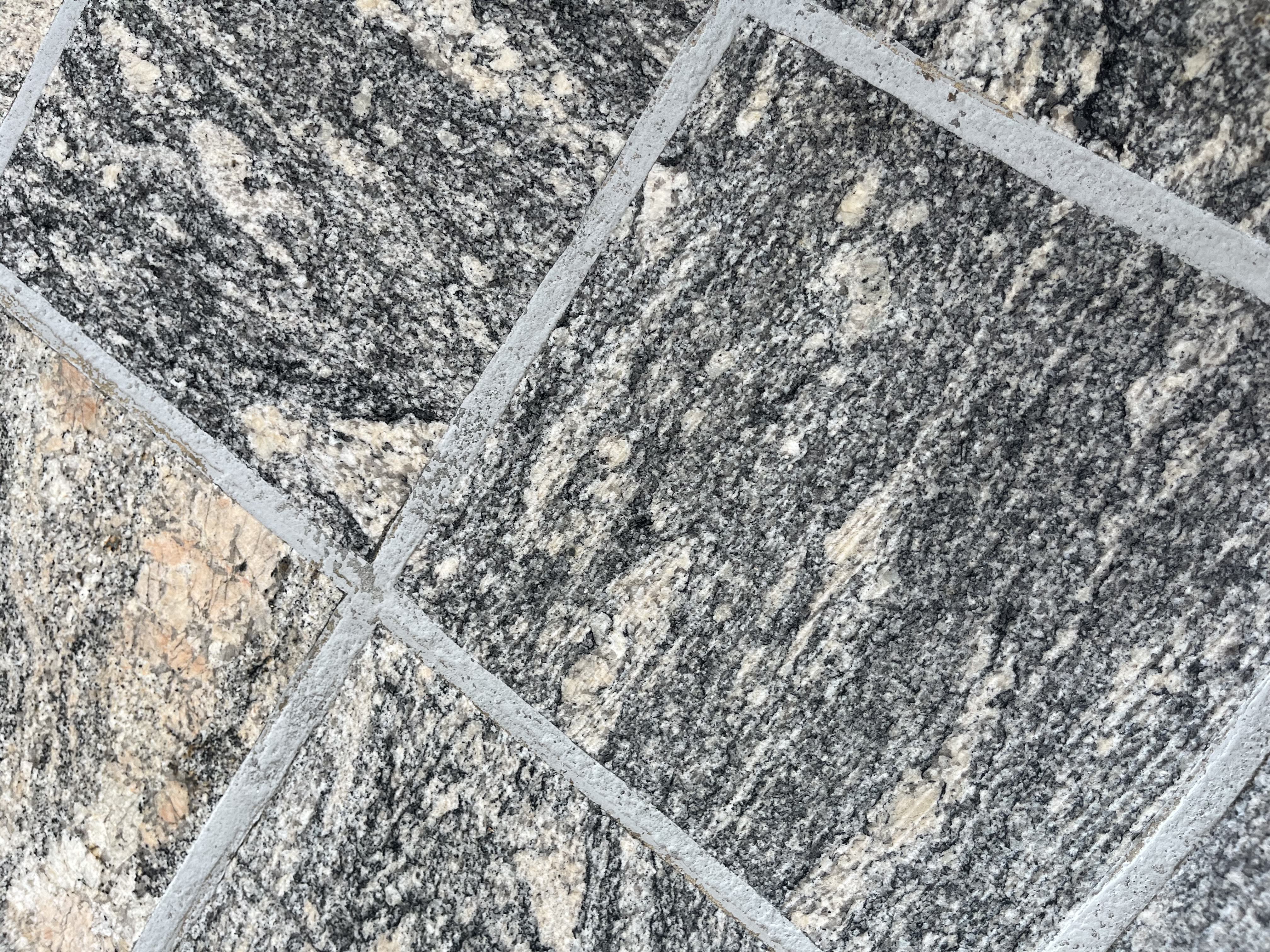 Square tiles approximately 1 foot by 1 foot in a gray and beige marble pattern.