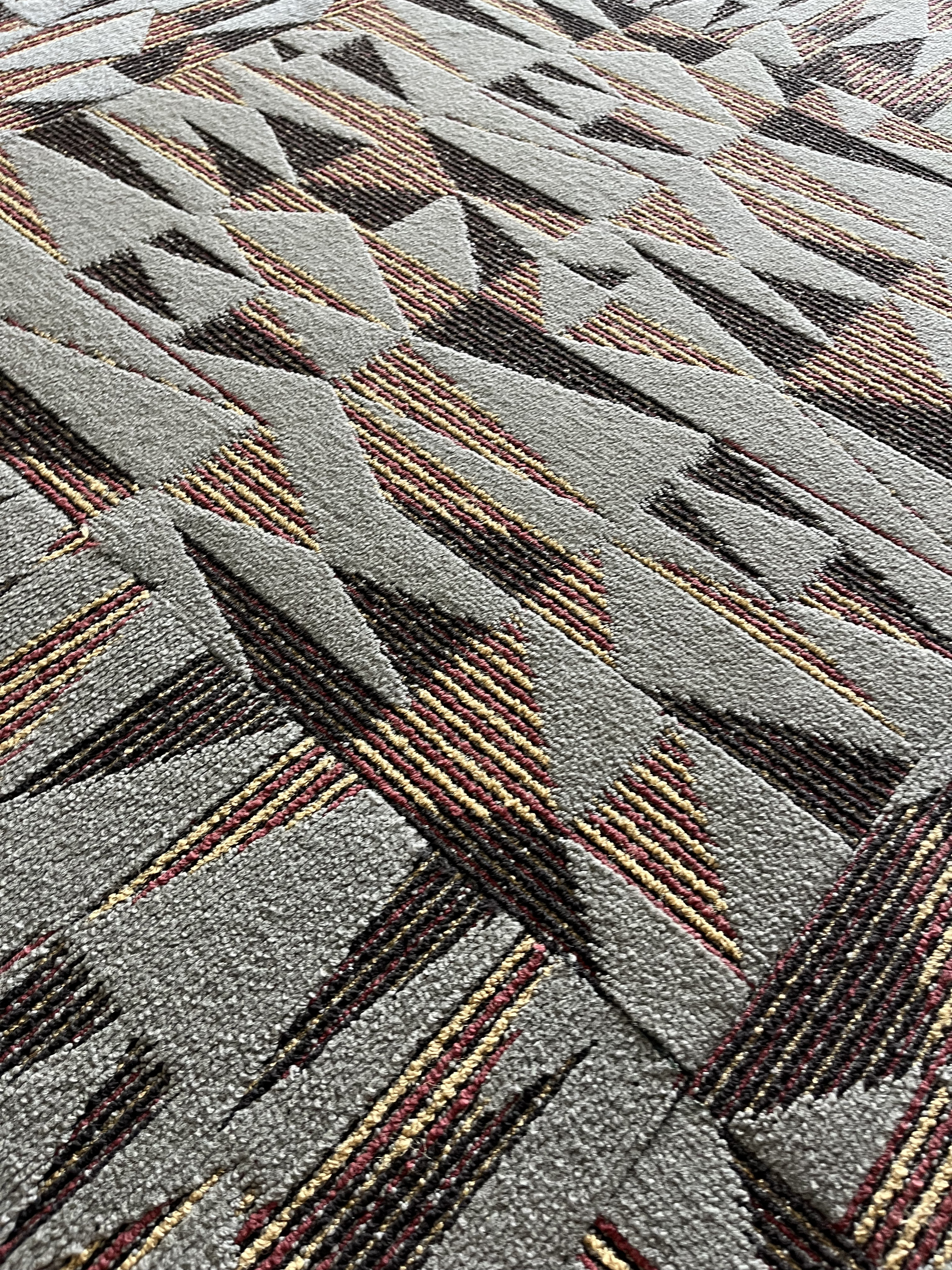 A triangular pattern of black, gray, and beige.